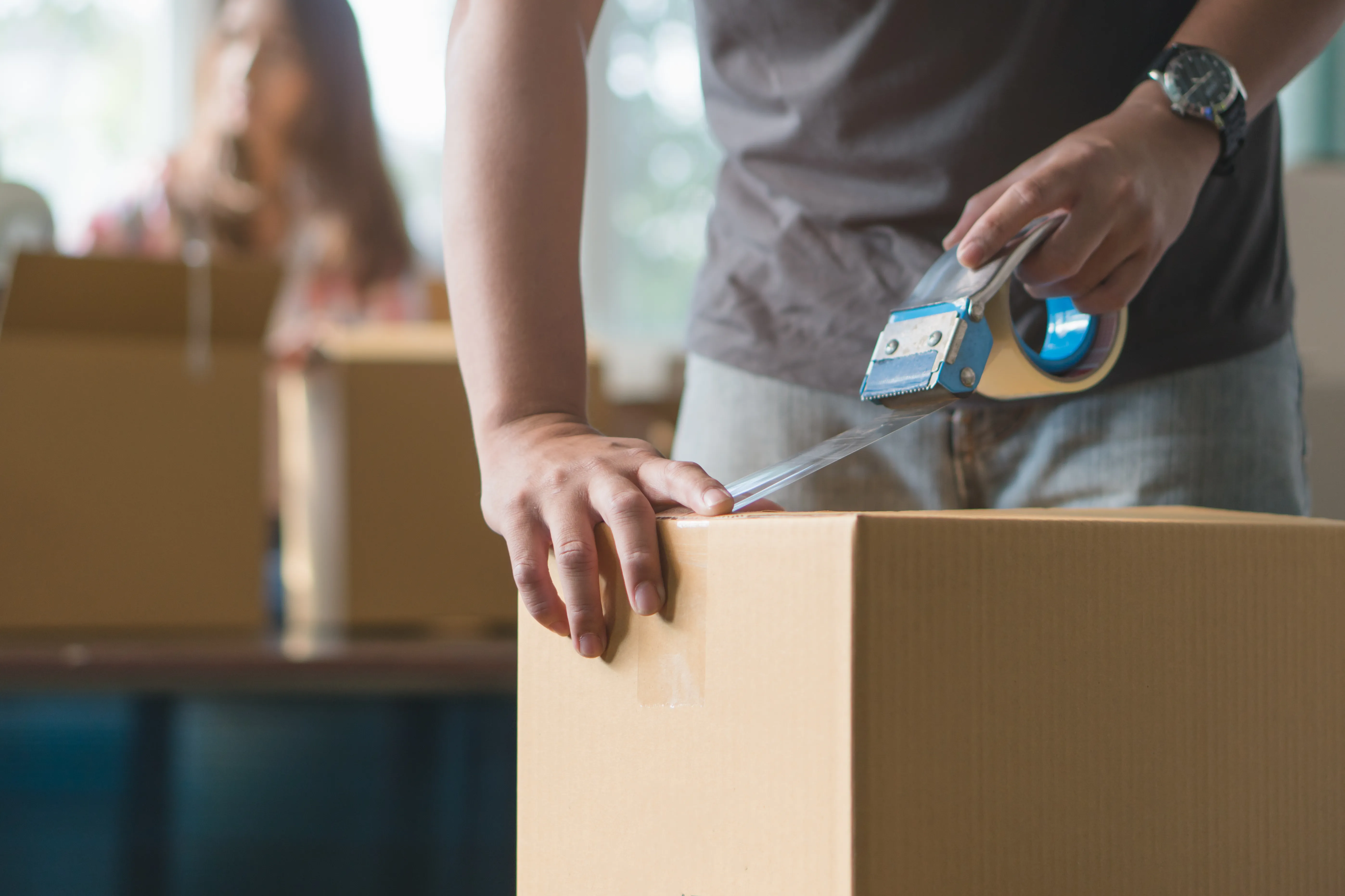 Person packing boxes for a move
